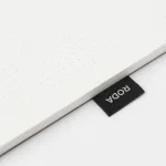 Edge view of the Roda Notepad showing the stacked dot grid sheets and RODA tab