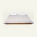 Mocha Brown with Haze Indigo Muted Layers Dohar shown made up on a low wooden platform bed with two matching pillows