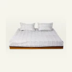Mocha Brown with Haze Indigo Pure Stripes Flat Bedsheet shown made up on a low wooden platform bed with two matching pillows