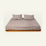 Mocha Brown with Haze Indigo Silent Stripes Flat Bedsheet shown made up on a low wooden platform bed with two matching pillows