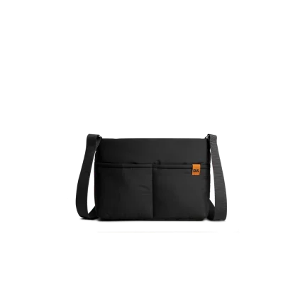 Carbon Black Retreat Crossbody Bag — compact crossbody with a webbing strap, shown on white