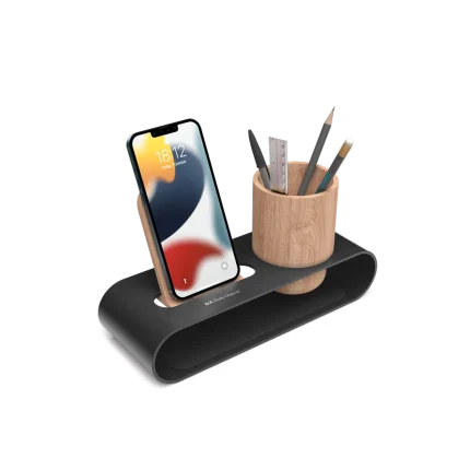 Cirque Phone and Pen Stand in black holding a phone upright beside the ashwood pen cup