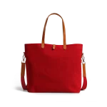 Crimson Red Buoy Tote Bag in red canvas with tan leather handles and a detachable shoulder strap