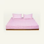 Berry Pink with Pearl Green Pure Stripes Flat Bedsheet shown made up on a low wooden platform bed with two matching pillows