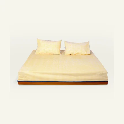 Mellow Yellow with Misty Blue Pure Stripes Flat Bedsheet shown made up on a low wooden platform bed with two matching pillows